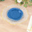 Elegant blue and clear decorative plate with gold trim on wooden table.