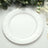 White paper plate on a table with greenery backdrop.