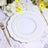 Elegant white plate with gold trim, styled with gold cutlery and floral accents.