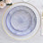 Decorative plates with intricate blue line patterns on a white table setting.