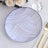 Decorative blue and white patterned plate on a textured tablecloth.