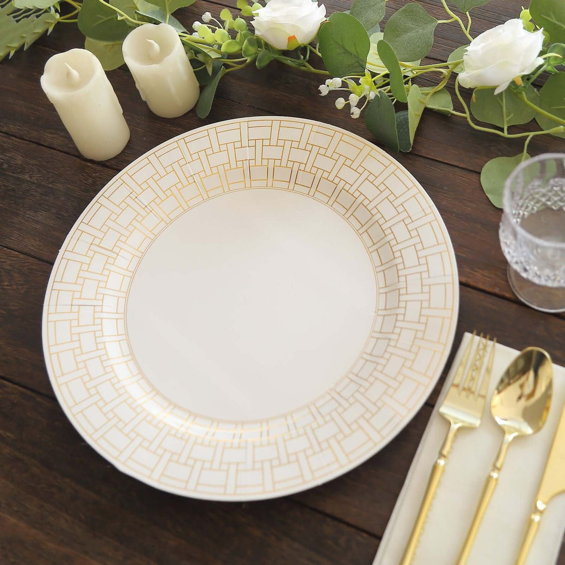 Elegant gold-accented dinner plate on a rustic wooden table setting.