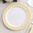 White plate with yellow decorative rim on neutral tablecloth.