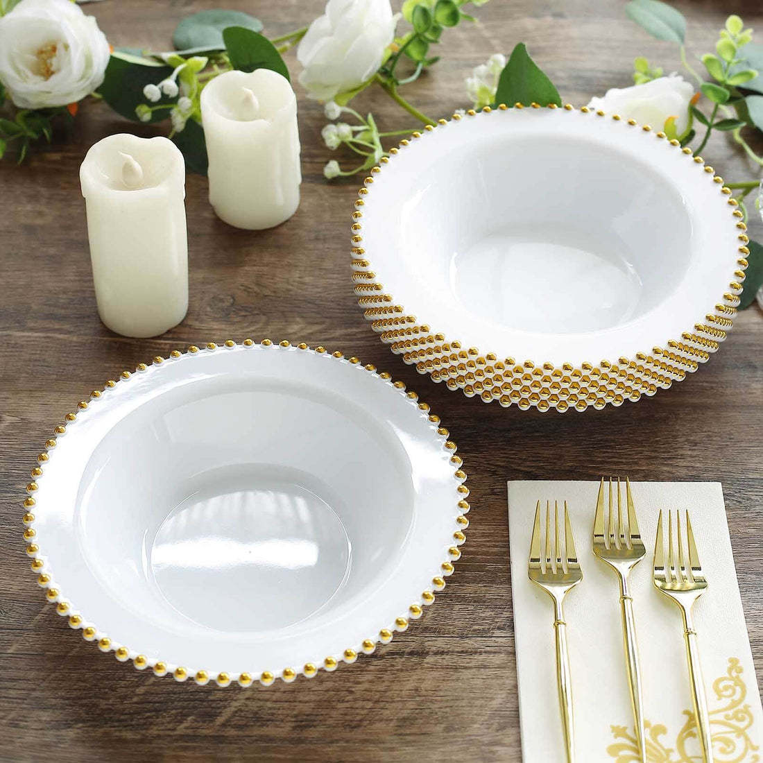 Elegant white bowls with gold beaded rim on a wooden table setting.