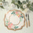 Floral decorative plate with gold trim on a table setting.