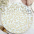 Decorative plates with gold leaf design on a white background.