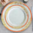 Elegant dinner plates with floral designs and gold accents.