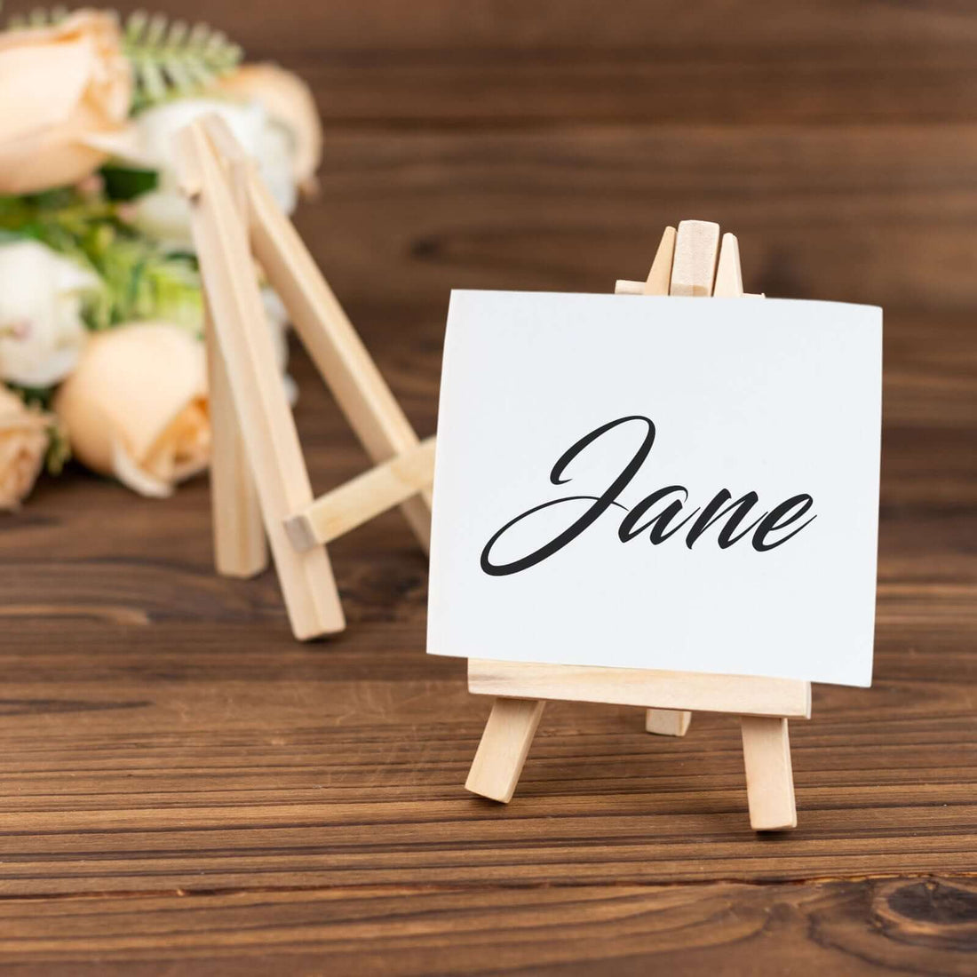 Name card on easel with "Jane" written in elegant script.