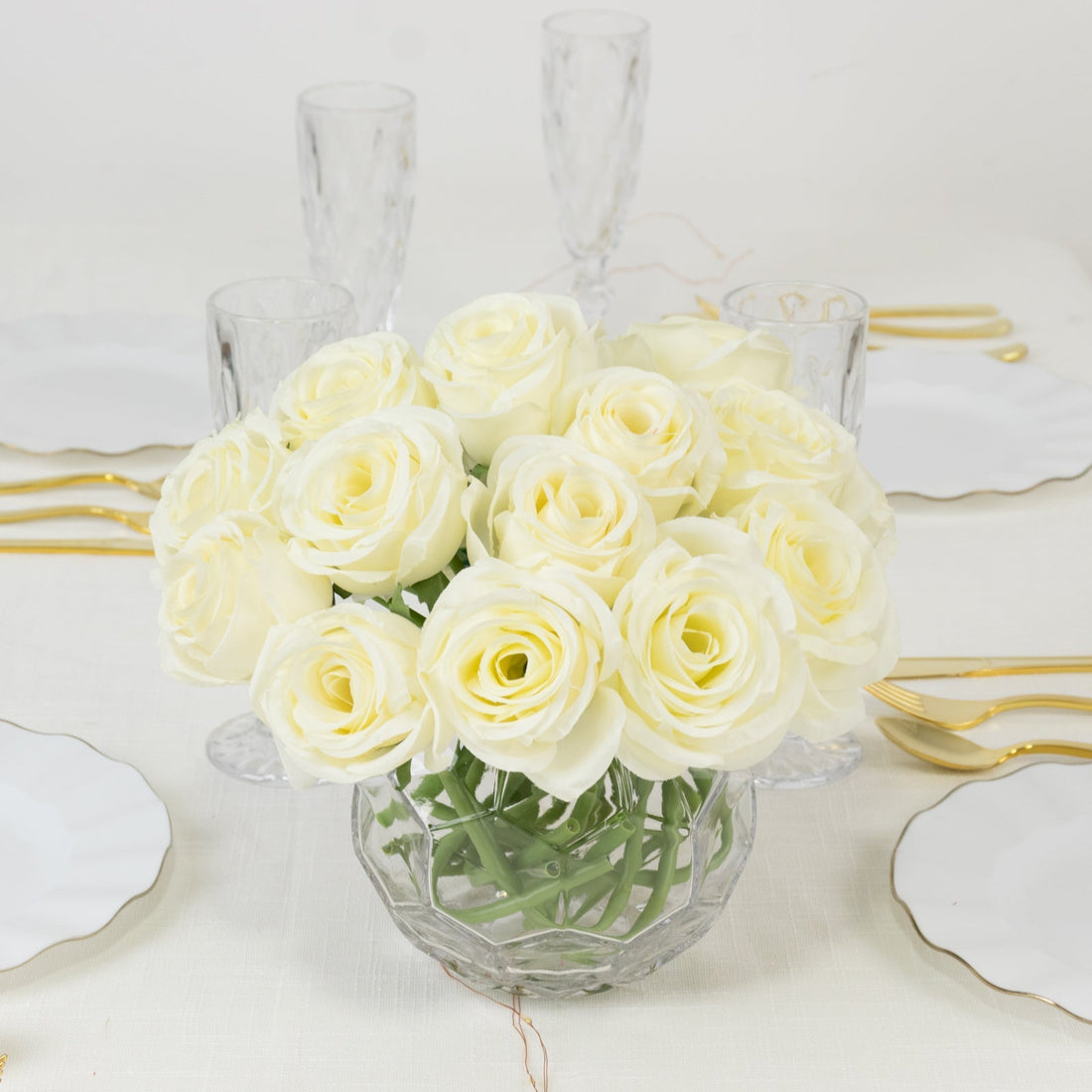 Bouquet of white roses in a glass vase on a dining table.