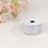 Silver ribbon spool with a flowing ribbon against a light background.