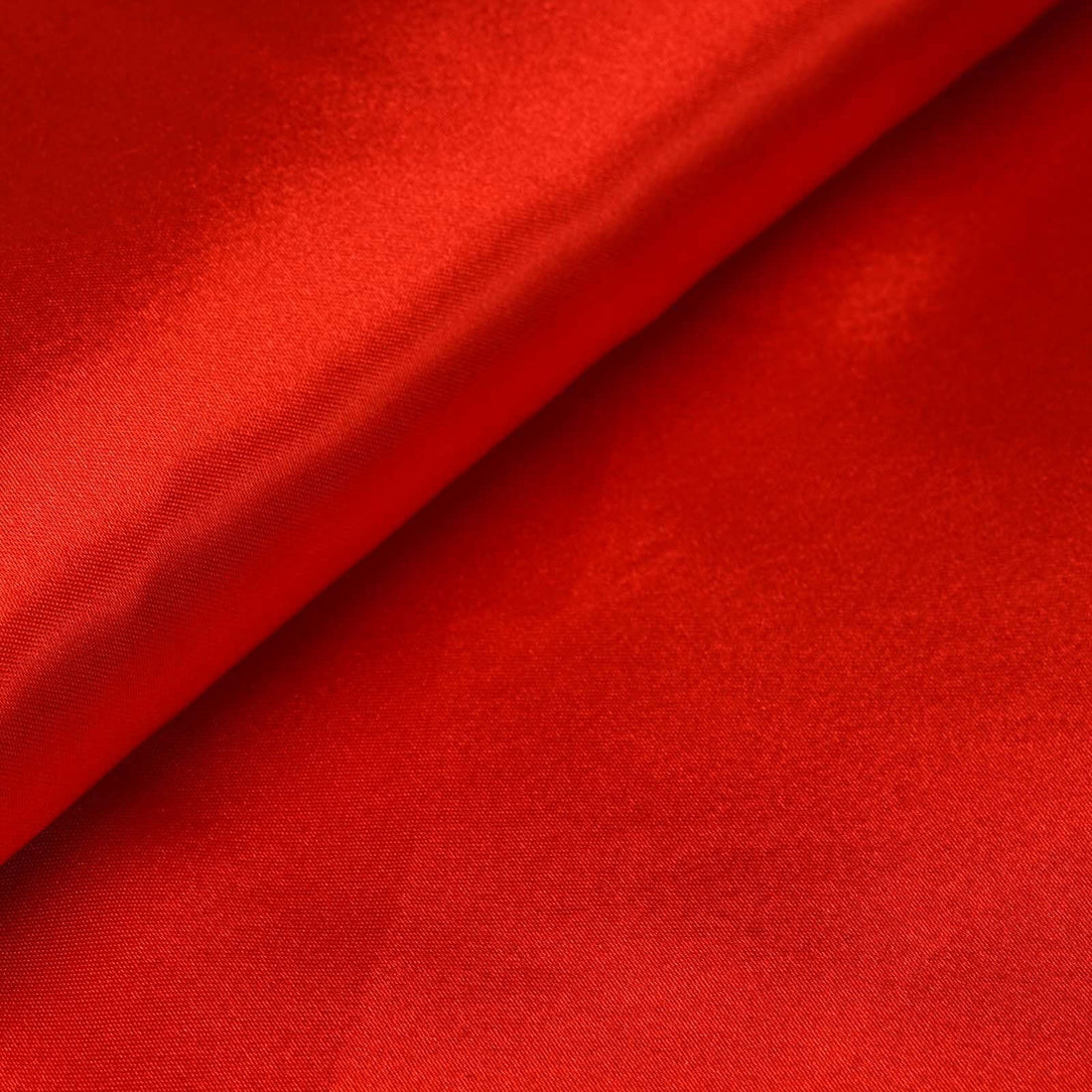 Red satin fabric with a smooth texture and sheen. #whtbkgd