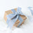 Gift box with blue velvet ribbon on a plain background