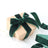 Green velvet ribbon gift box on a plain backdrop.