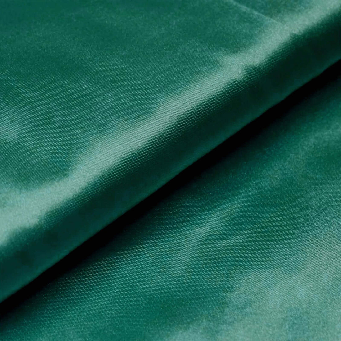 Green satin fabric with a smooth texture and subtle sheen. #whtbkgd