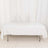 White table with a clean tablecloth on a plain backdrop