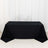Black tablecloth on a plain backdrop for event styling.