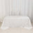 White tablecloth draped elegantly over a table against a plain backdrop