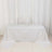 White tablecloth draped over a table in a studio setting.