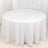Round white table with a flowing tablecloth.
