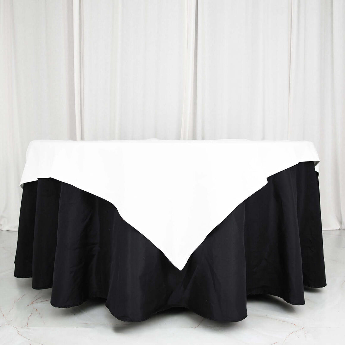 Black and white tablecloth with a triangular design on a round table