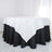 White and black tablecloth on a round table in a bright setting.