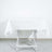 White tablecloth on a folding table against a plain background.
