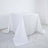 White table covered with a plain tablecloth on a studio backdrop