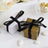 Elegant white and gold gift boxes with black ribbons for weddings or special events.