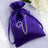 Purple satin drawstring pouch with rhinestone design.