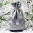 Silver satin favor bag with drawstring closure and logo.