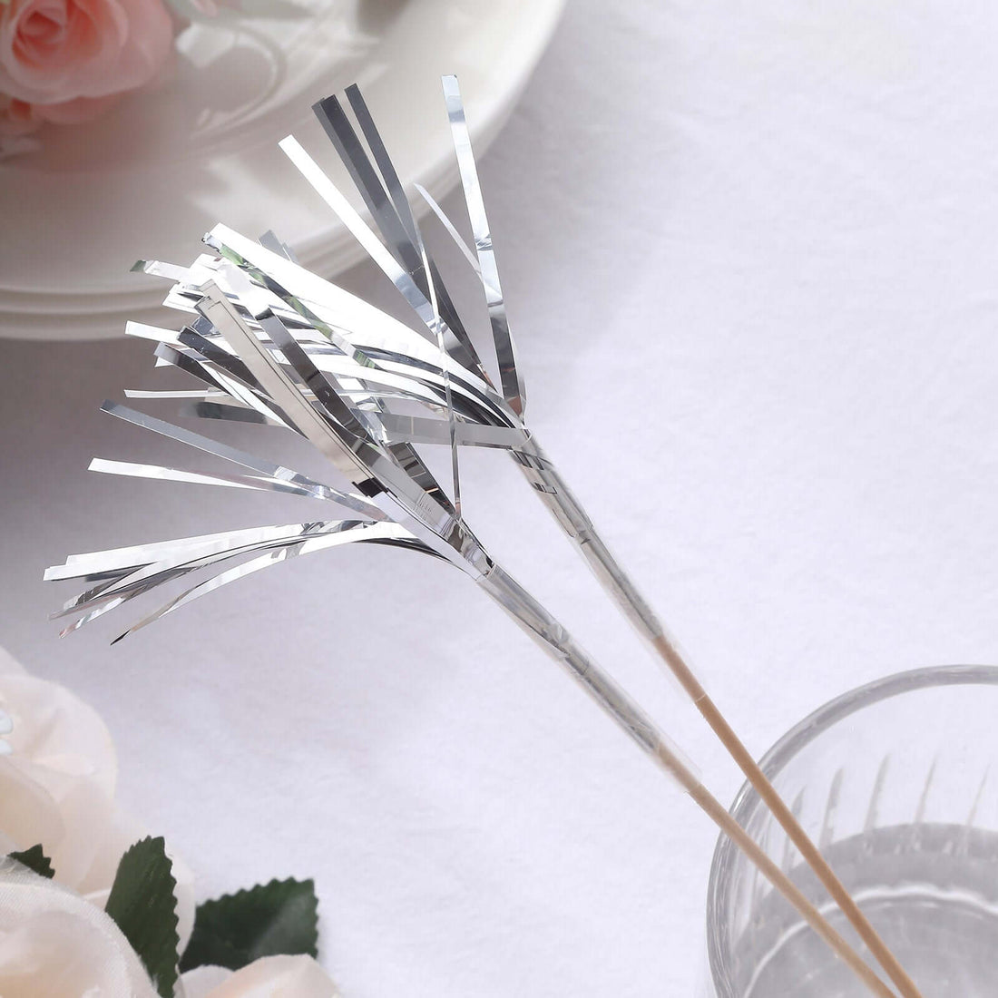 Silver decorative metallic straws with a wooden base.