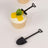 Mini shovel cupcake topper with mango and mint garnish.
