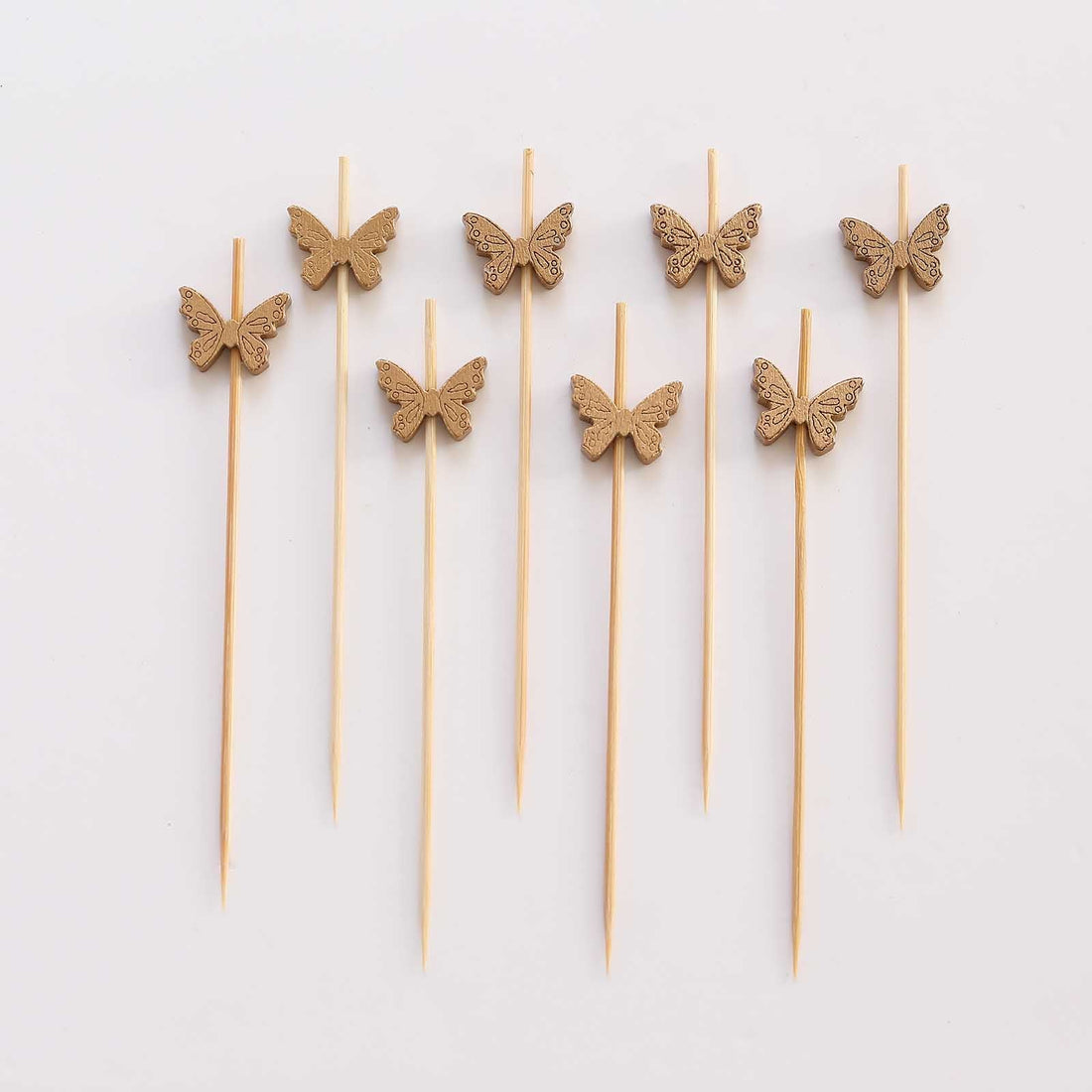 Wooden butterfly cake toppers on skewers for decoration