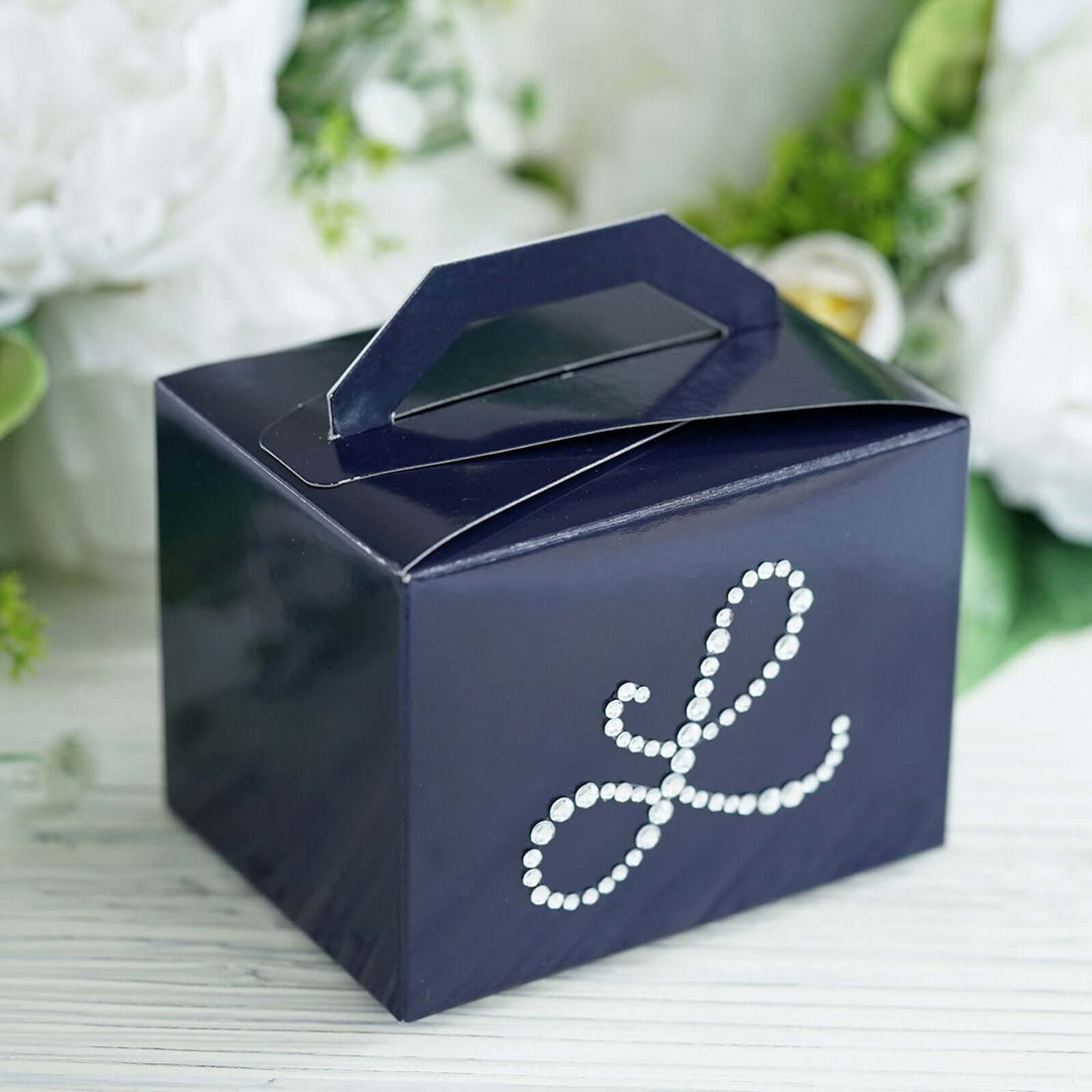 Navy gift box with decorative rhinestone letter "L" design.