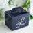 Navy gift box with decorative rhinestone letter "L" design.