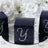 Navy gift boxes with rhinestone 'Y' on a mirrored surface surrounded by flowers. #whtbkgd
