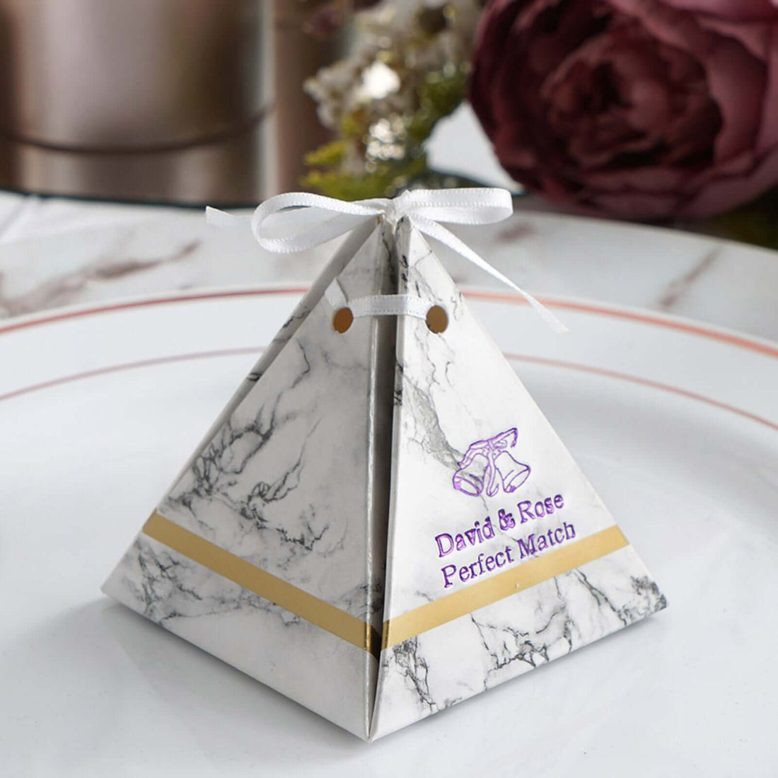 Marble-patterned pyramid favor box with ribbon for weddings or events. #whtbkgd