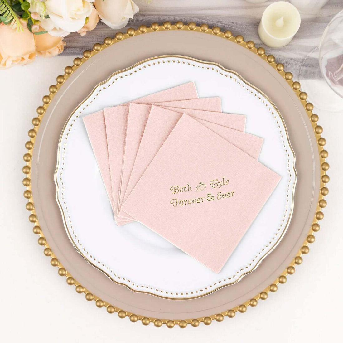 Pink napkins with "Beth & Tyler Forever & Ever" text on a decorative plate.