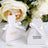 Wedding favor boxes with personalized names and dates, decorated with bows.