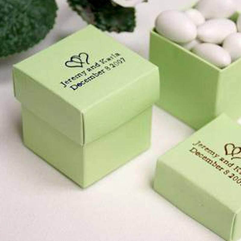 Green gift boxes with personalized labels for weddings.