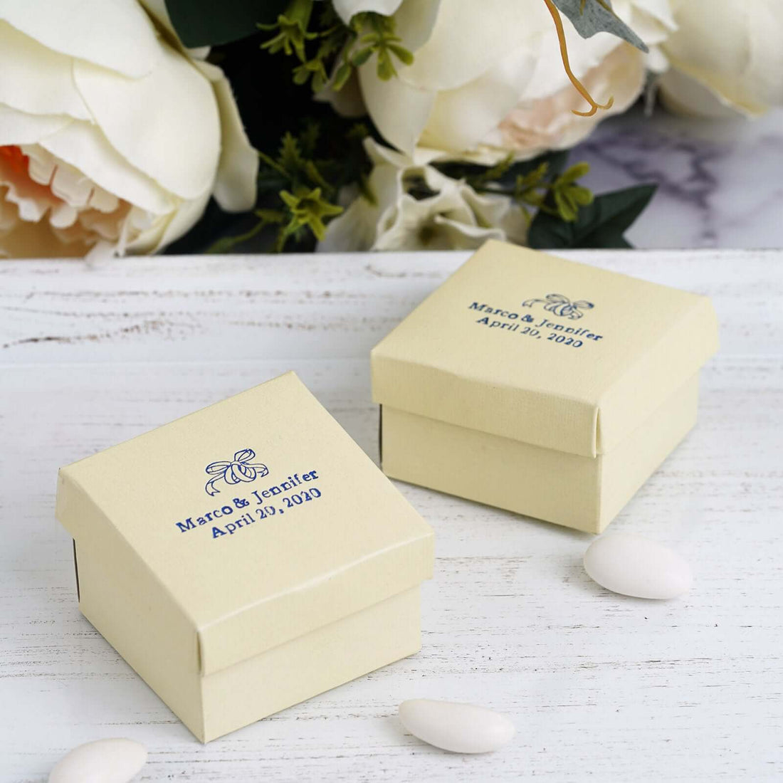 Personalized wedding favor boxes with custom names and date, cream color.