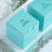 Turquoise gift boxes with personalized labels for a wedding.