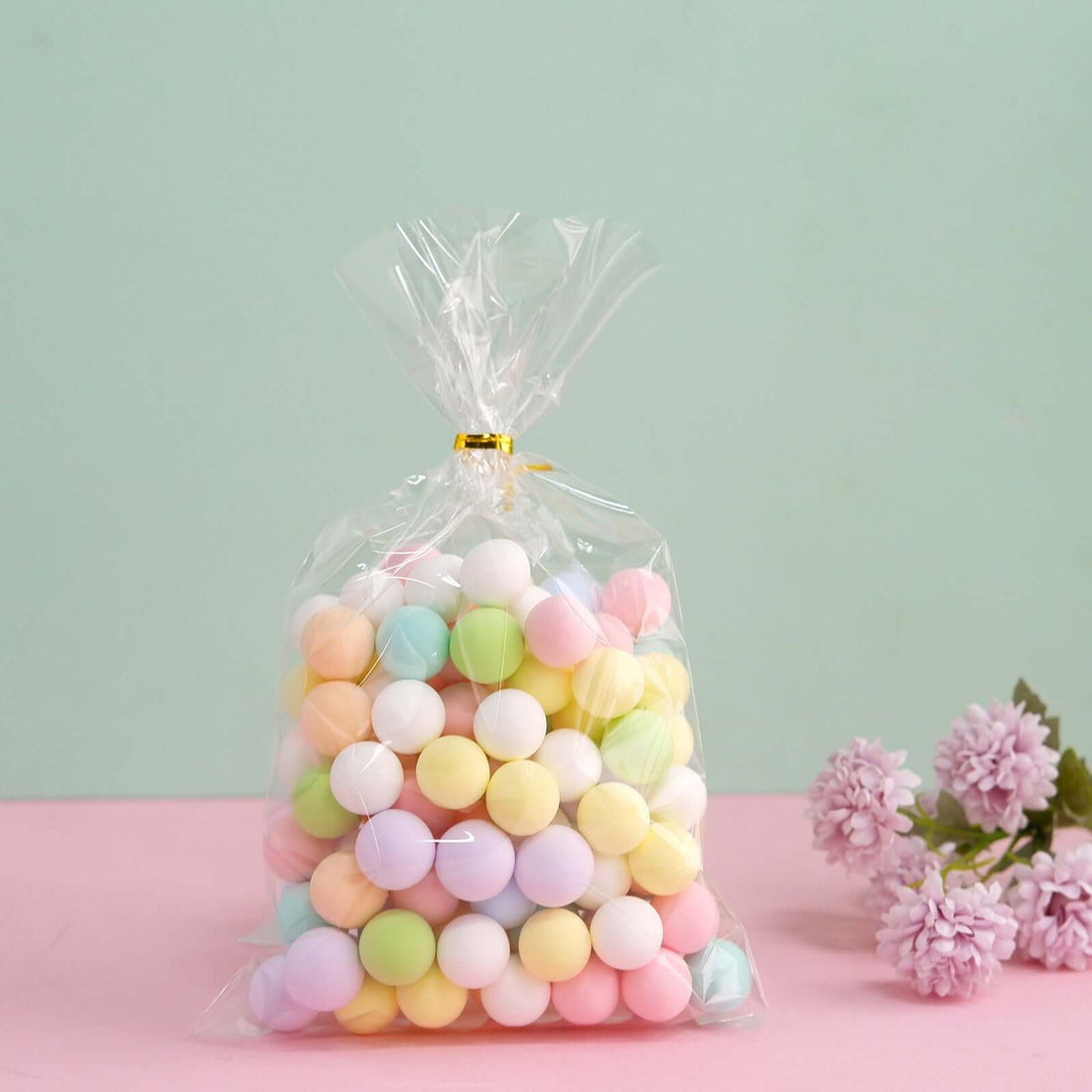 Colorful pastel foam balls in a clear bag for craft projects.