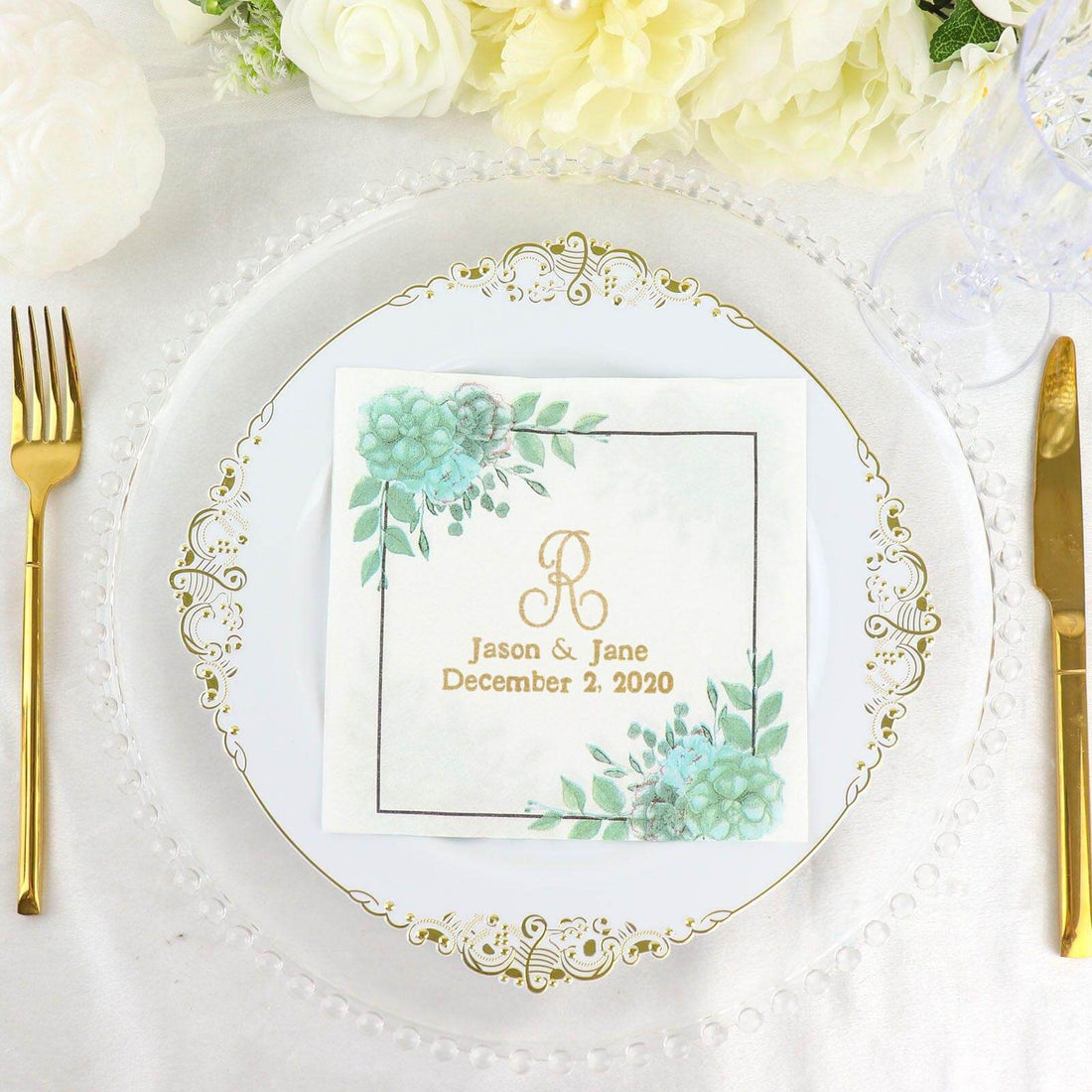 Elegant wedding napkin with floral design and gold lettering on a decorative plate.