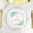 Elegant wedding napkin with floral design and gold lettering on a decorative plate.