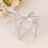 Clear gift box with a silver ribbon bow on a soft background.
