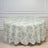 Round floral tablecloth in green and white on a plain backdrop.