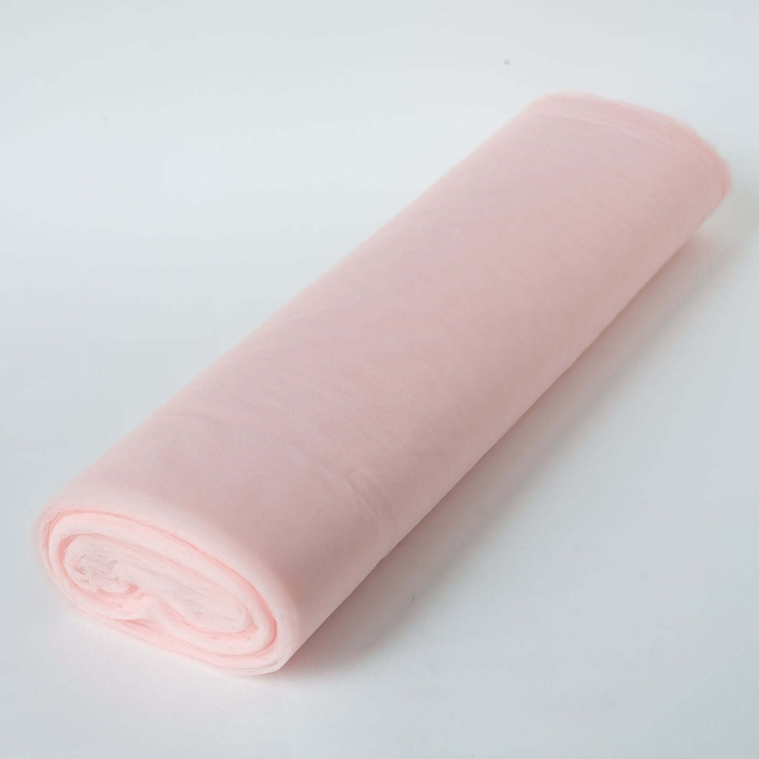 Pink fabric roll on a white background
