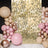 Balloon arch decoration with a shimmering gold backdrop for events.