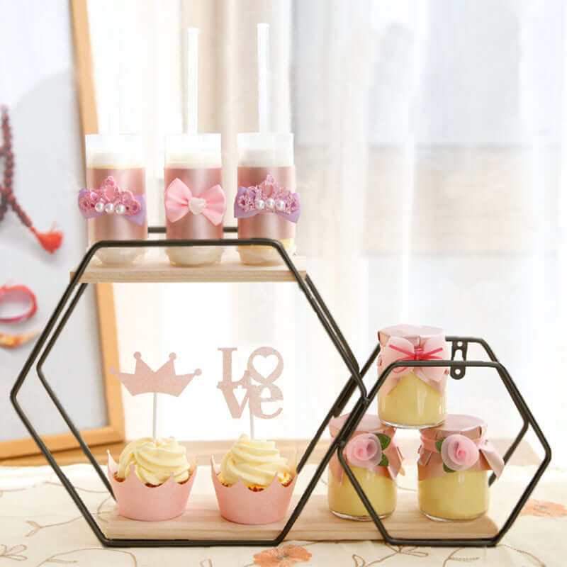 Decorative dessert display with cupcakes and layered treats in a stylish stand.